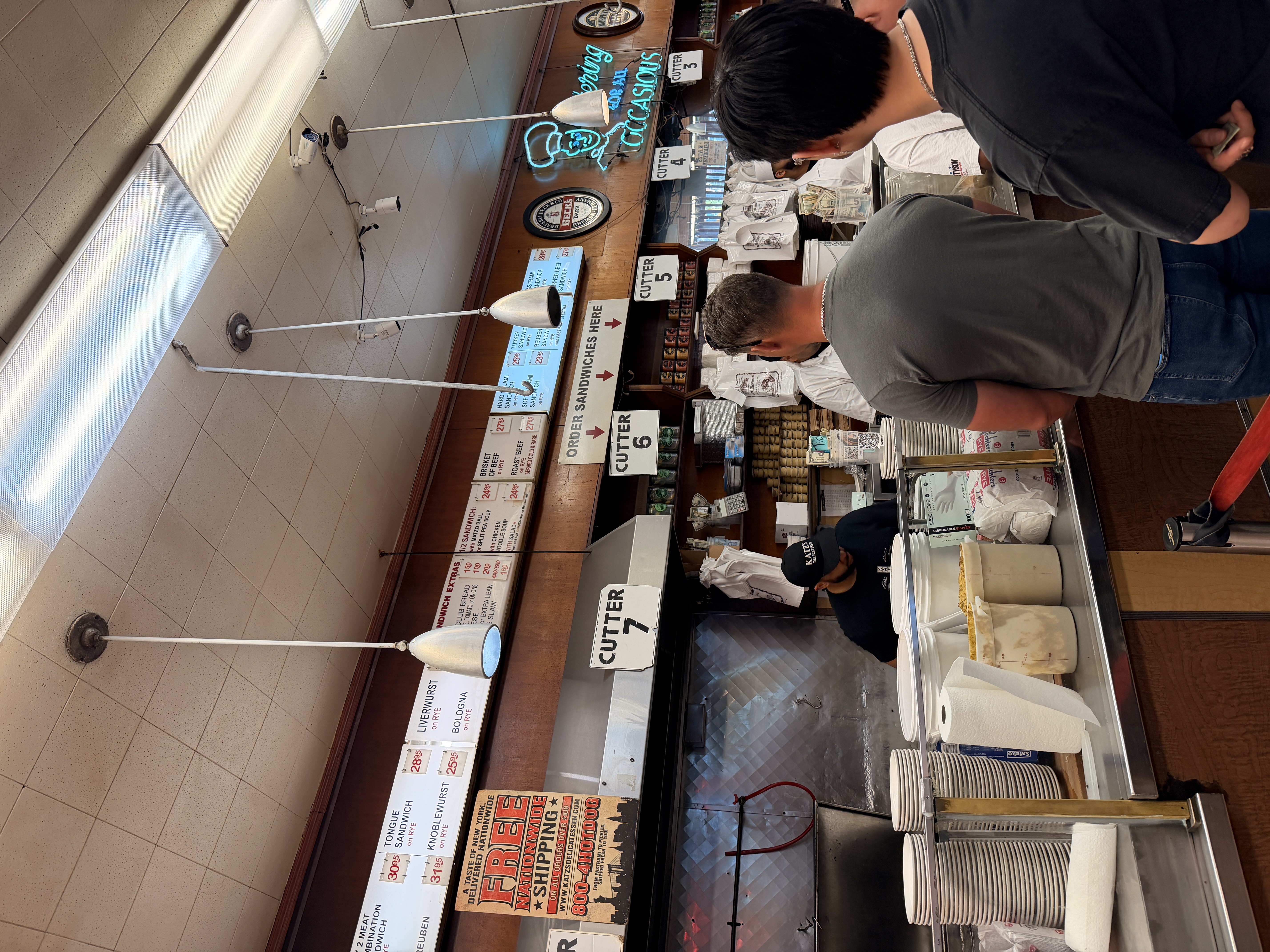 Customers ordering at the counter inside Katz's Delicatessen