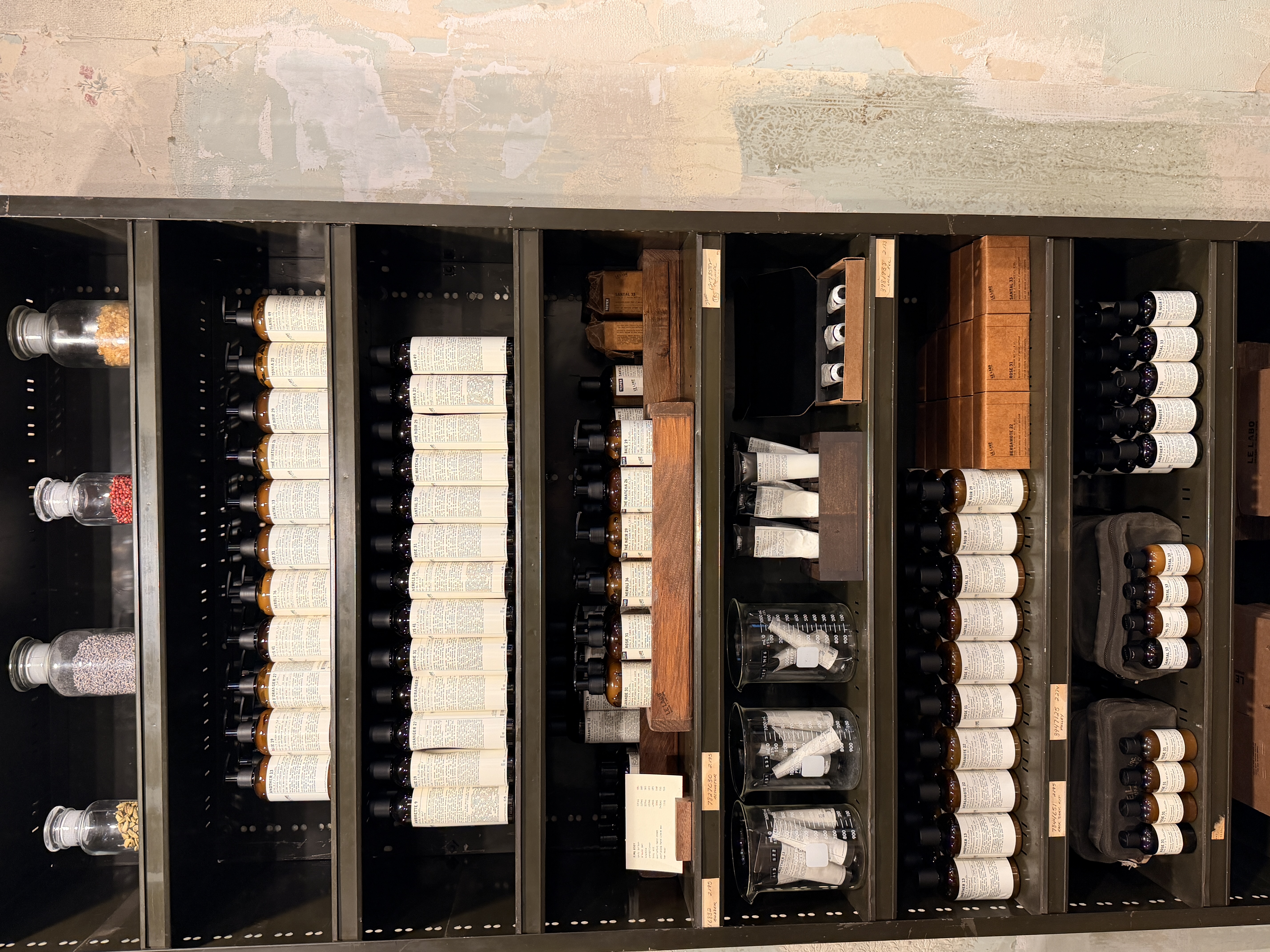 Apothecary shelves lined with amber bottles and glass jars